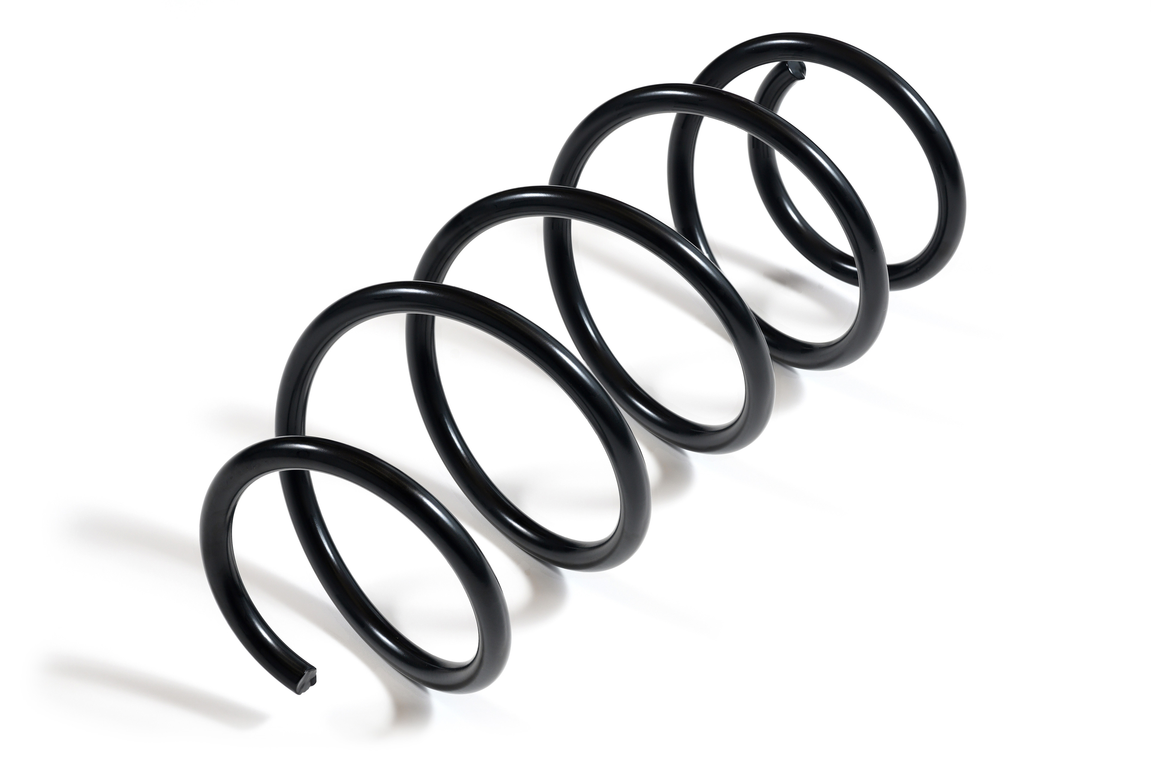 A black metal compression springs with a glossy finish is photographed against a white background. The spring spirals smoothly.