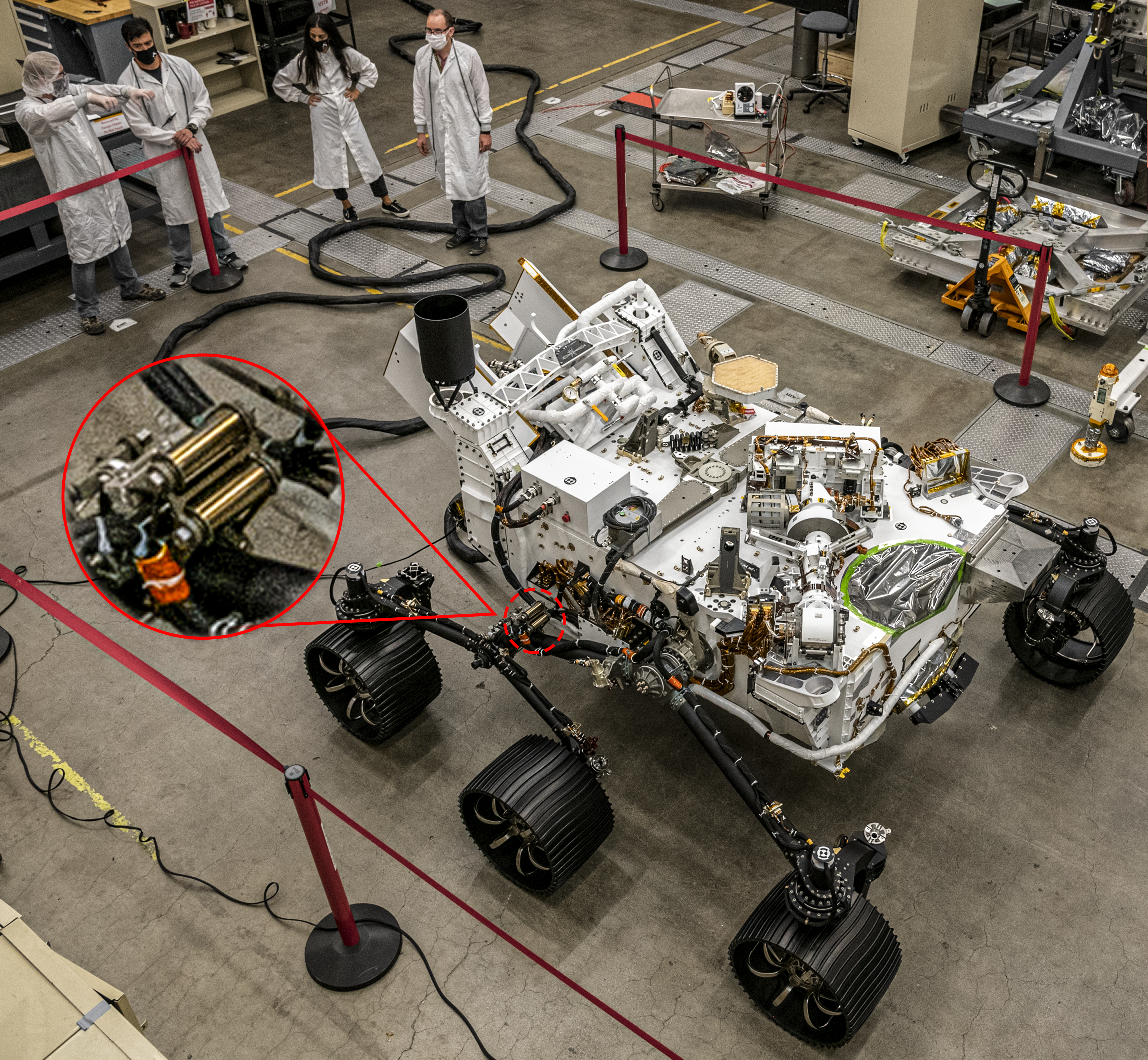 NASA's Perseverance Mars rover being assembled at NASA's Jet Propulsion Laboratory, with an inset highlighting the John Evans' Sons constant force springs used in the rover's suspension system