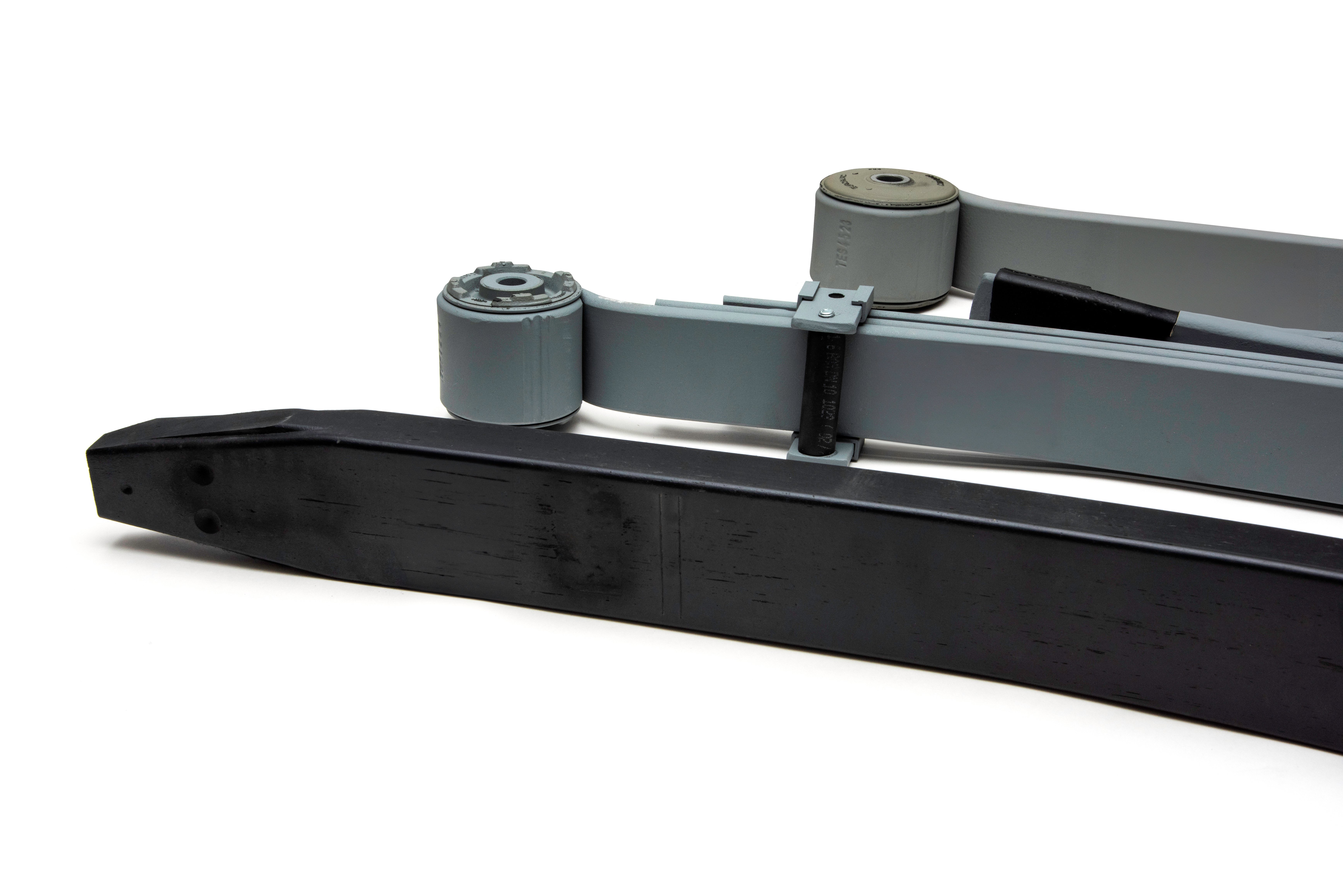 Close-up of three leaf springs in grey and black aligned side by side on a white background.