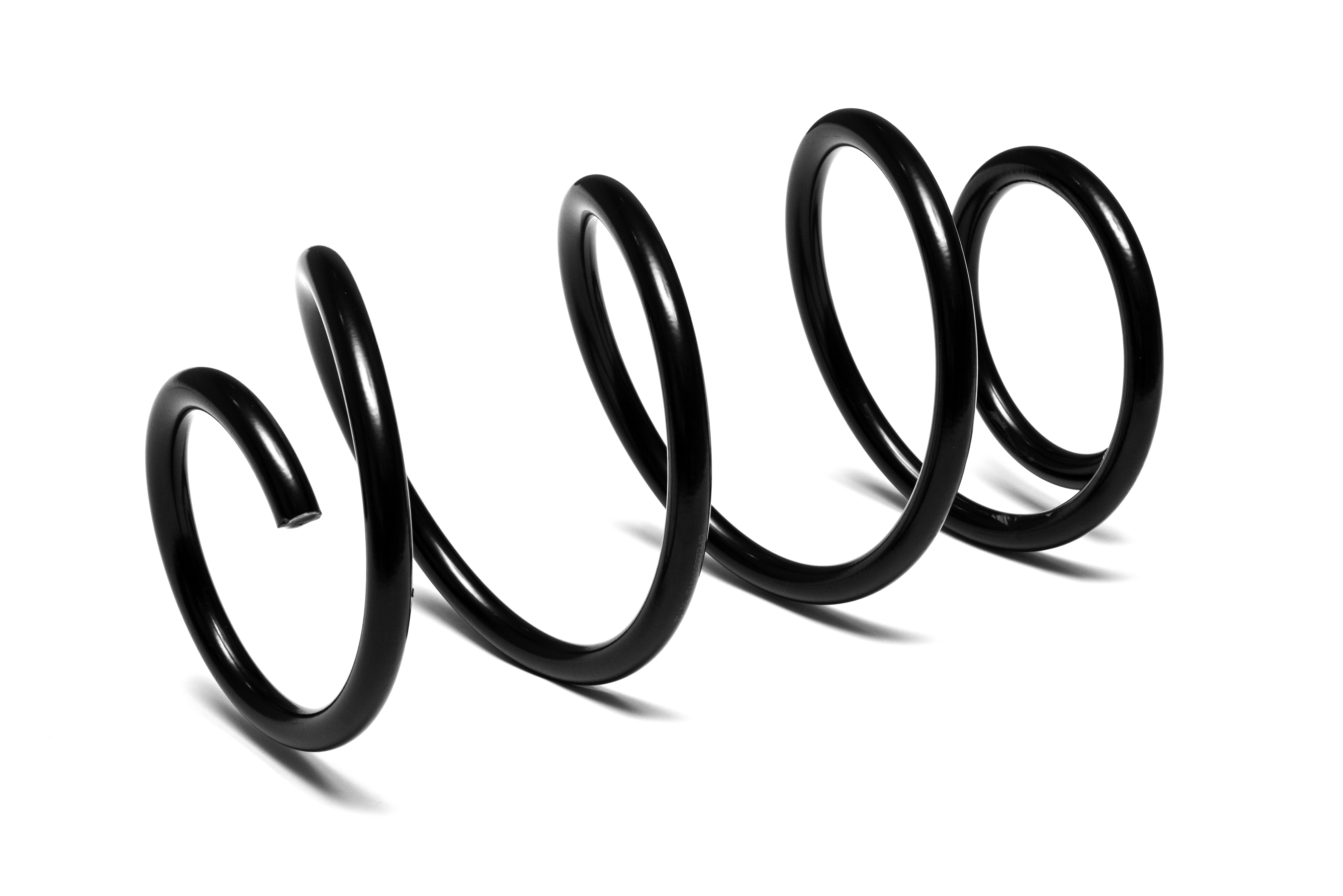 A black coil spring in a horizontal position against a white background, casting a shadow beneath. 