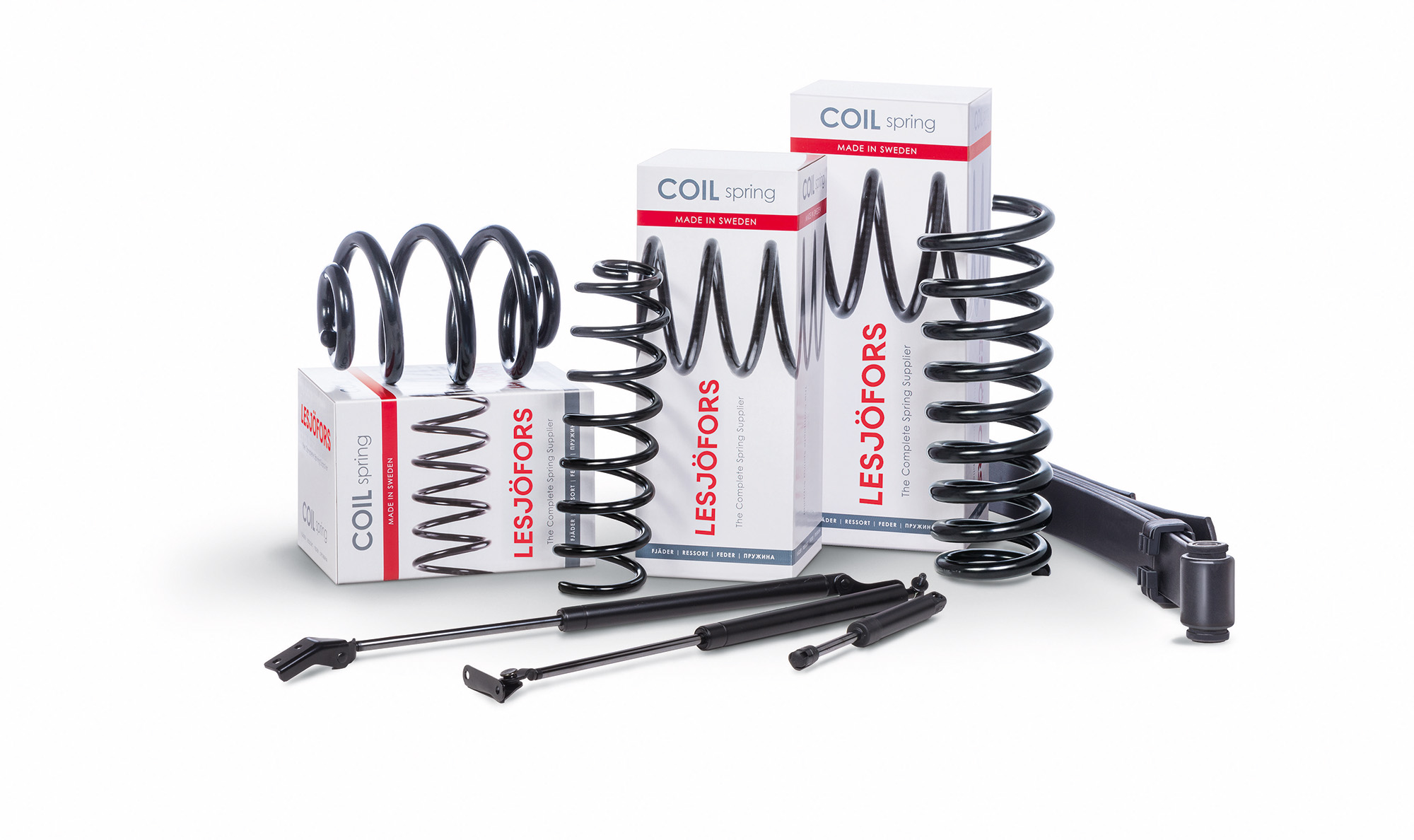 A variety of suspension, compression, and chassis springs are displayed against white packaging featuring a red and black “Lesjöfors” logo.