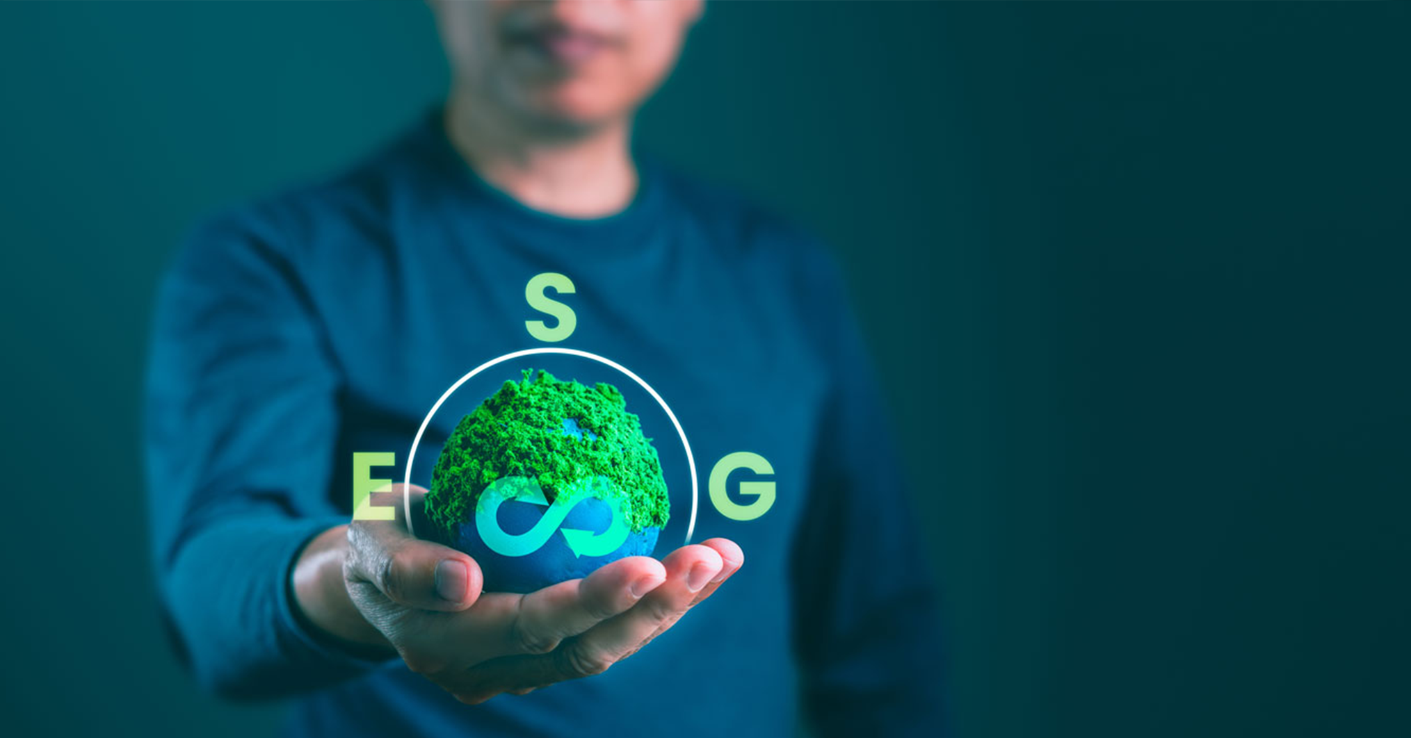 A person holds a glowing green digital globe with a recycling symbol, surrounded by the letters E, S, G, symbolizing environmental sustainability.