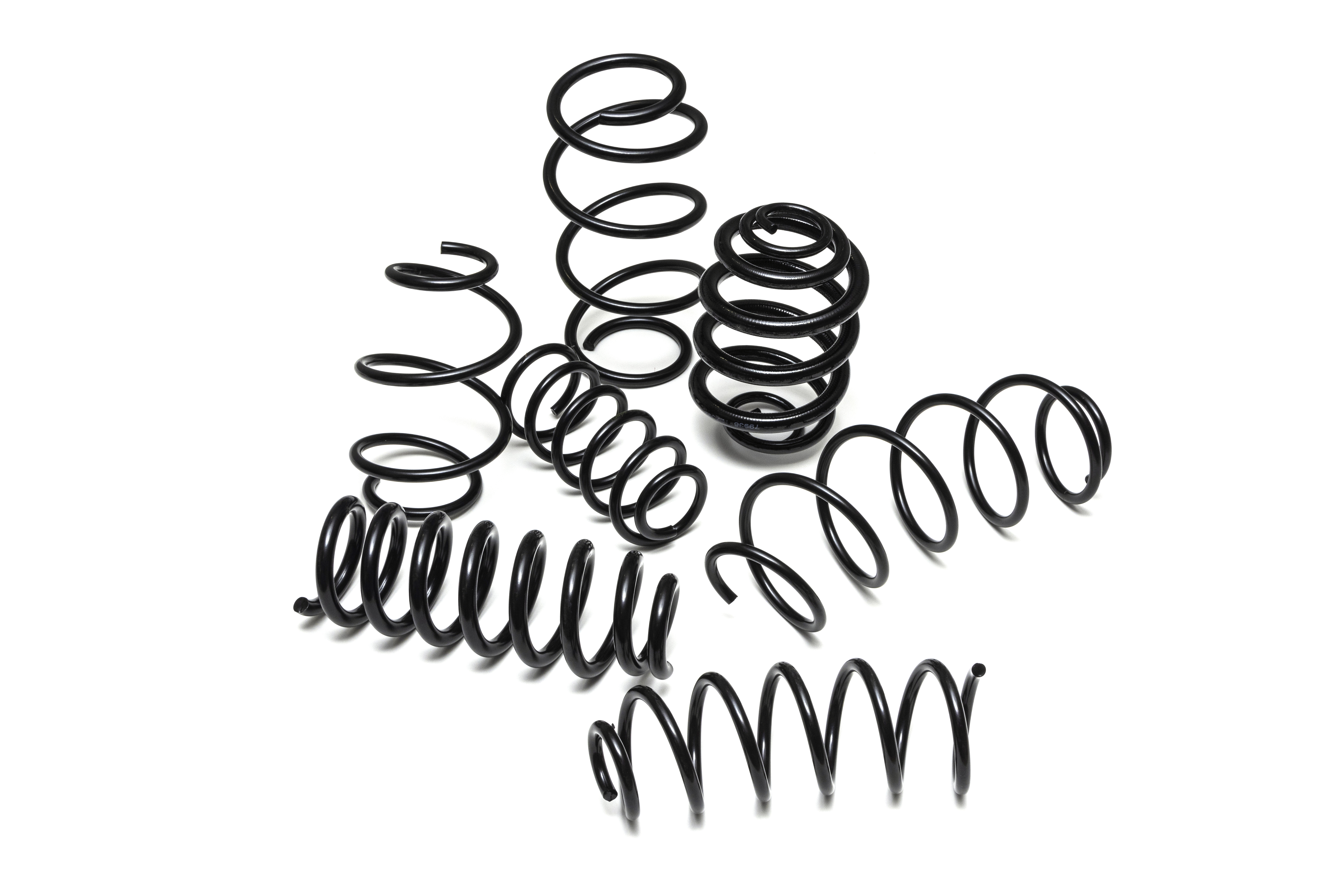 A variety of black metal coil springs of different sizes and shapes are randomly arranged against a plain white background.