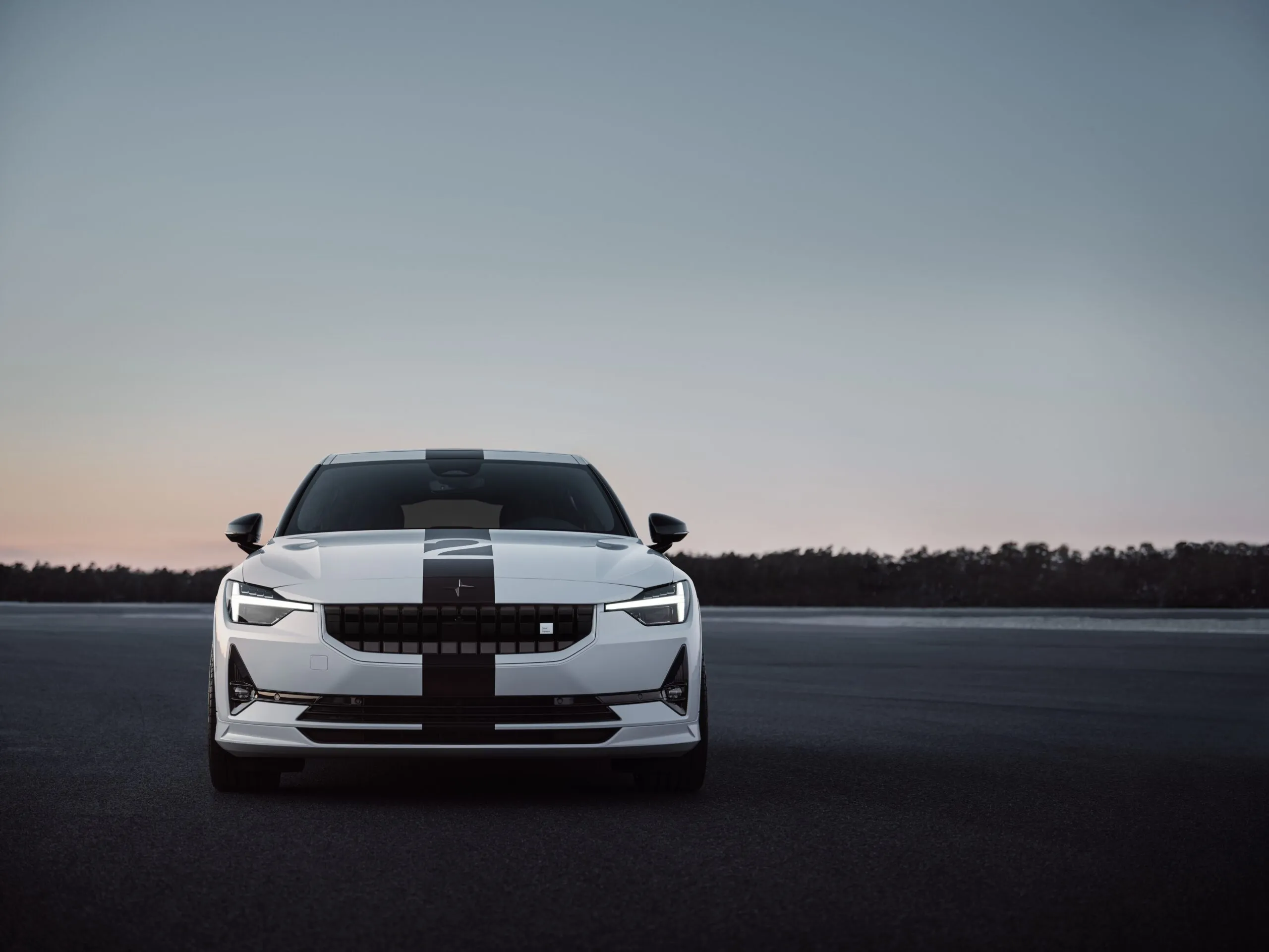 A front angle shot of the Polestar 2 BST edition on a race track.