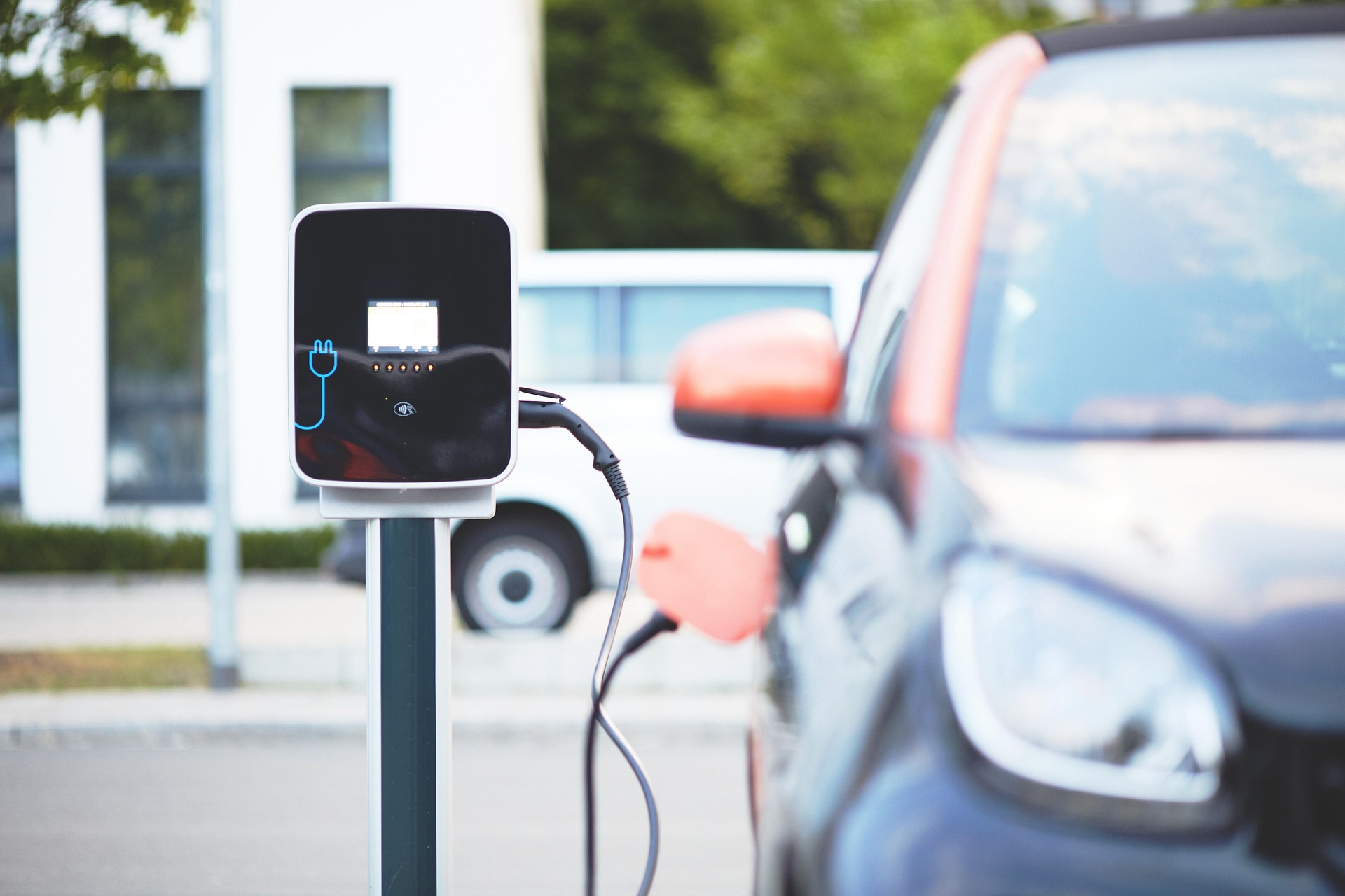 Electric car charging at a public charging station.