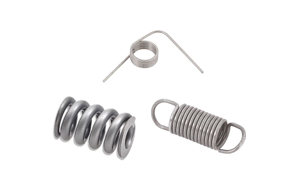 Three metal stock springs: a compression spring, an extension spring with hooks, and a torsion spring.