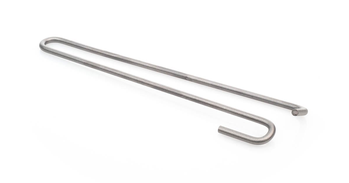 A torsion bar spring, a silver metal hook with a U-shaped bend resting on a white background.