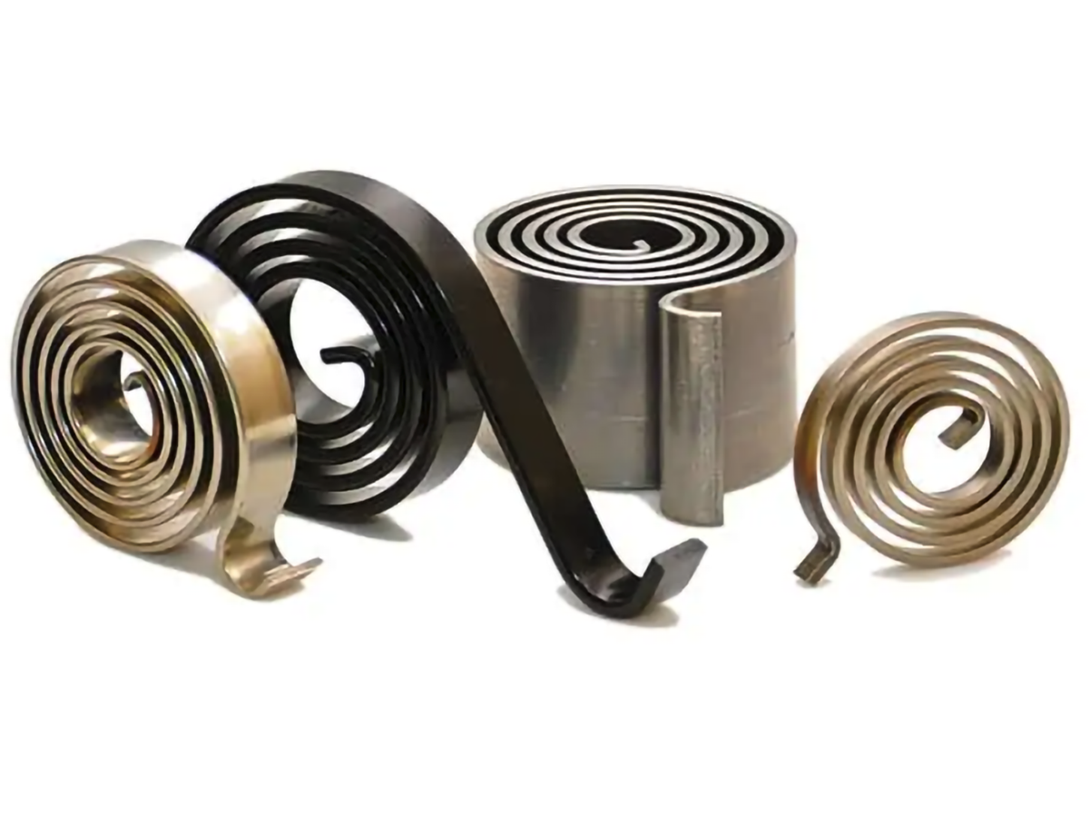Four spiral torsion springs of varying sizes and colors, including silver and black, stand upright on a white background, showcasing their tension and flexibility.