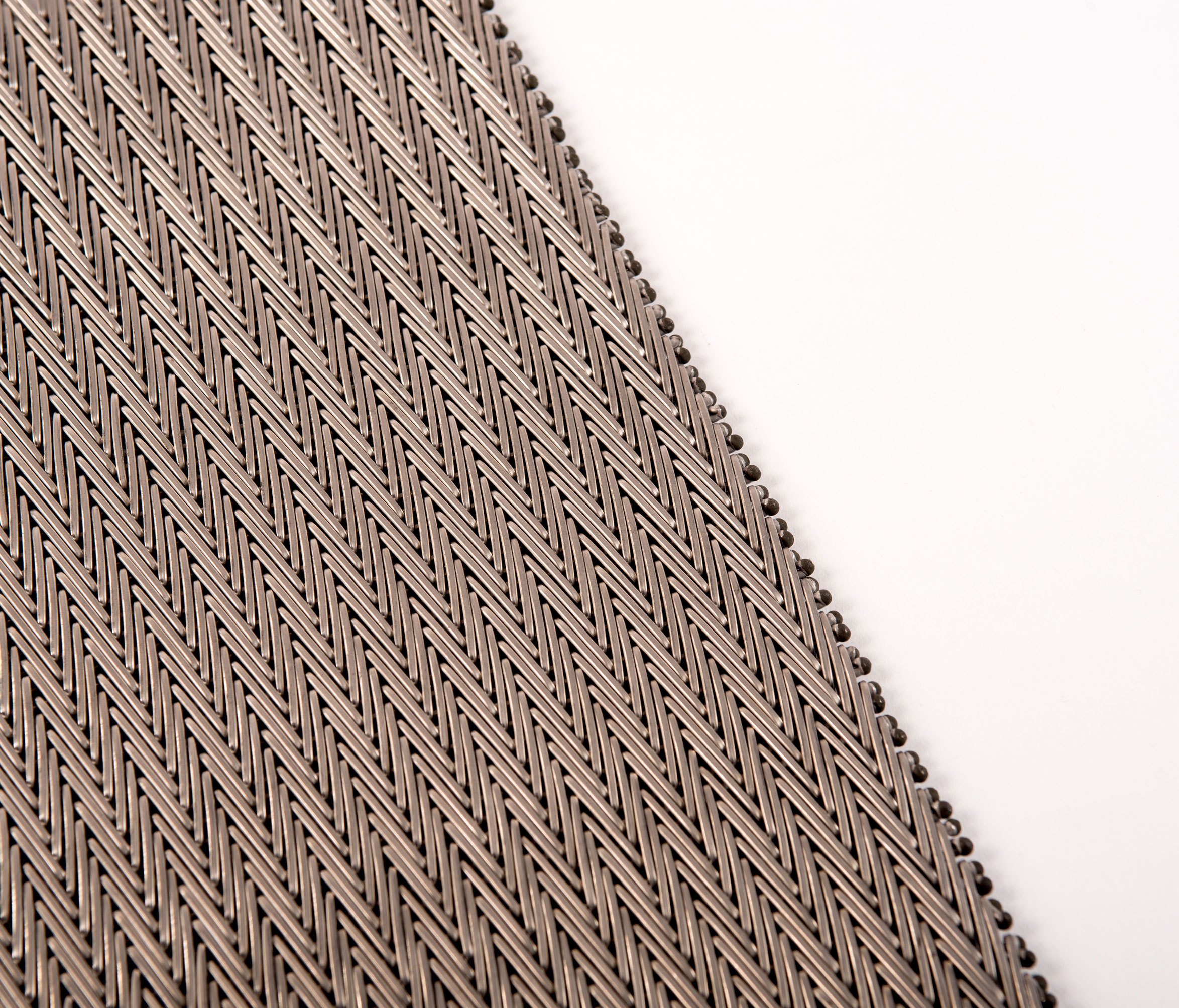 Close-up of a textured, gray-brown compound balanced belt positioned against a white background. The image emphasizes texture and contrast.