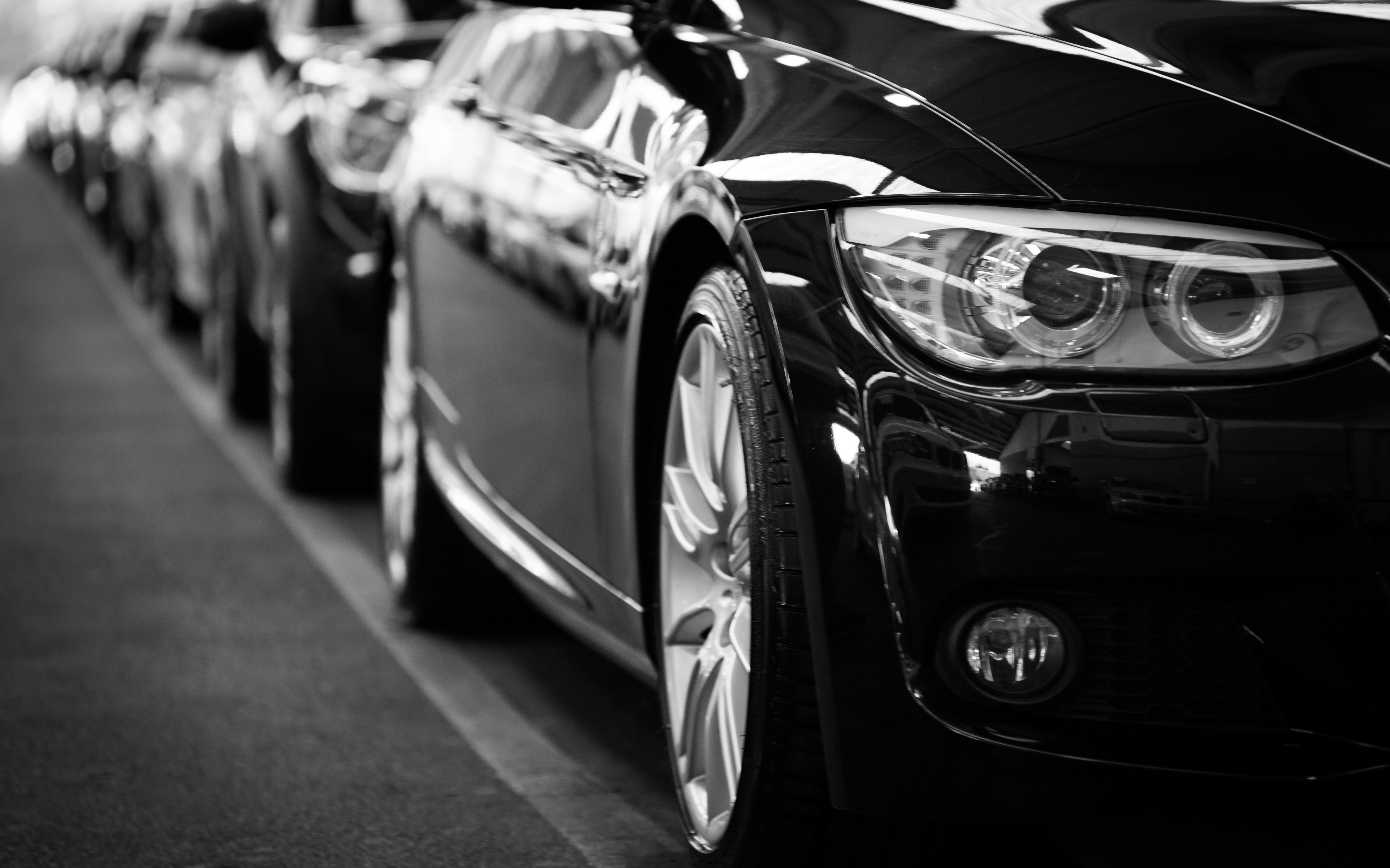 Close-up of a row of newly built cars.