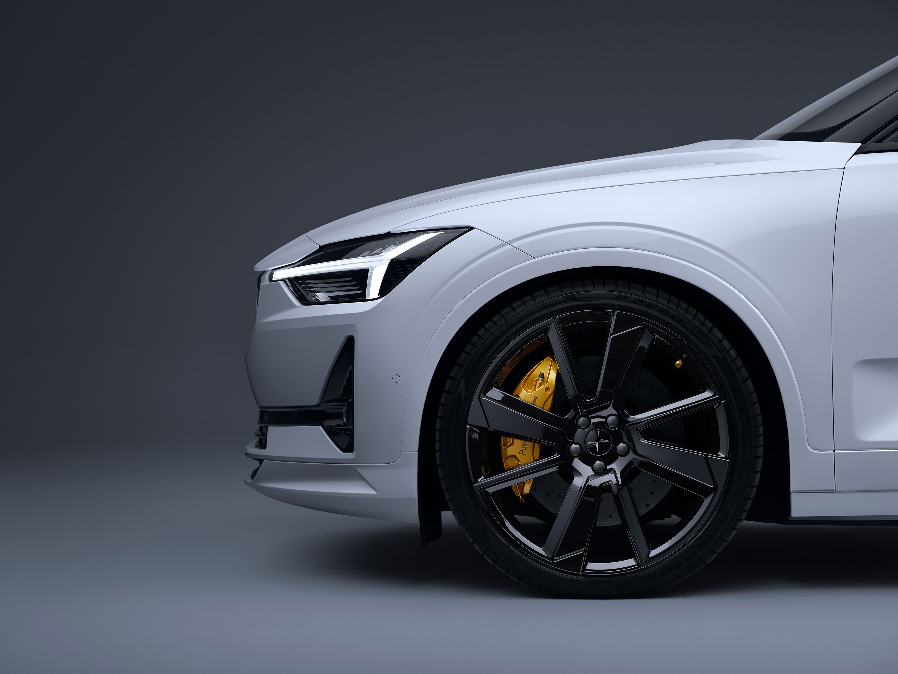 Side view of the bonnet and front left wheel of a white Polestar.